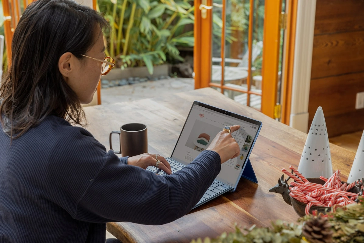 a woman using a touch screen laptop