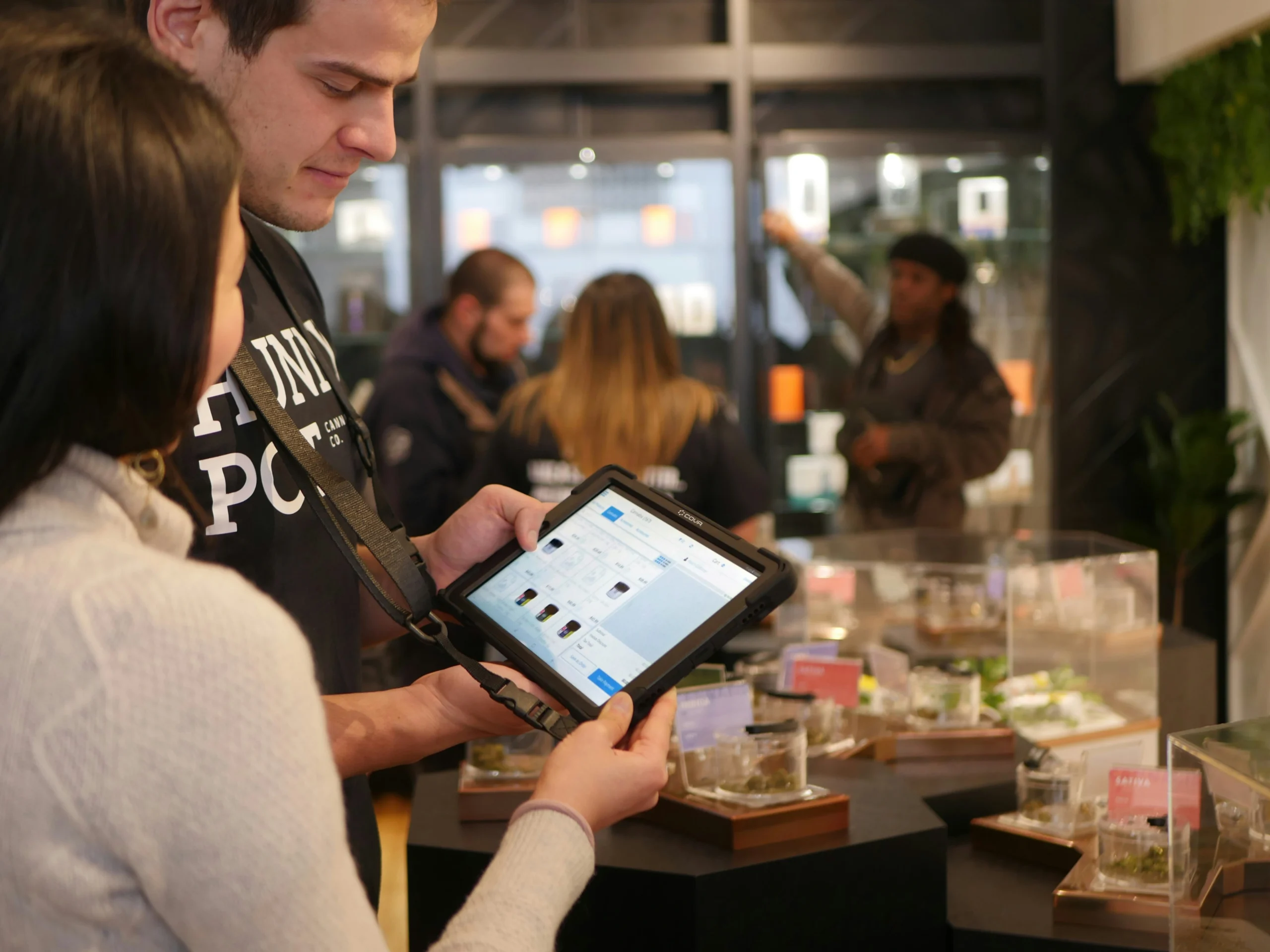 two people looking at products on a tablet in a retail store